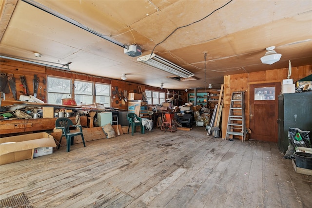 miscellaneous room with wood-type flooring and a workshop area