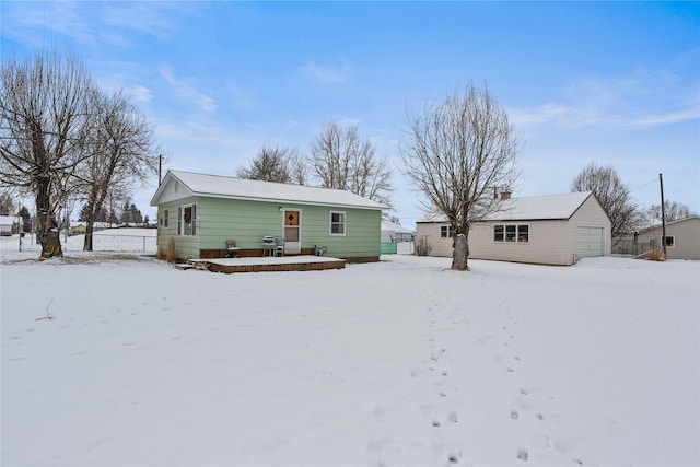 snow covered house with a garage