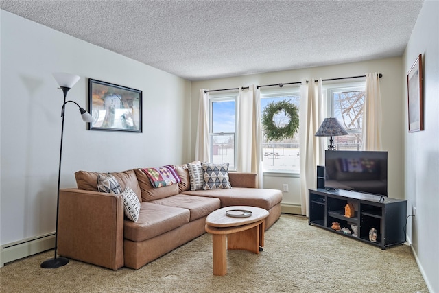 carpeted living room featuring a baseboard heating unit, a wealth of natural light, and a textured ceiling