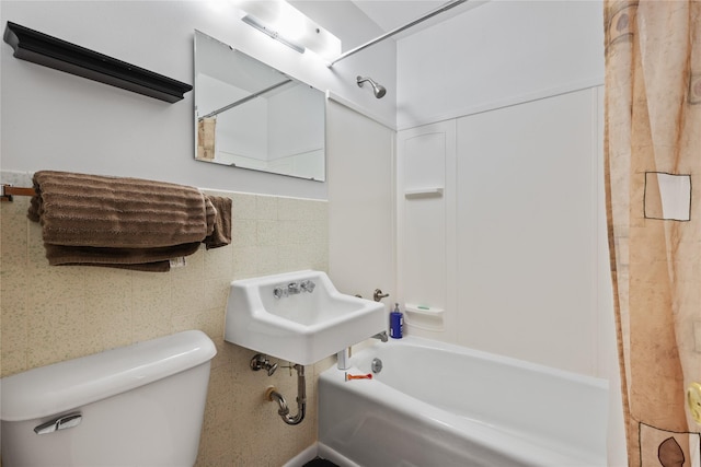 full bathroom with shower / washtub combination, sink, tile walls, and toilet