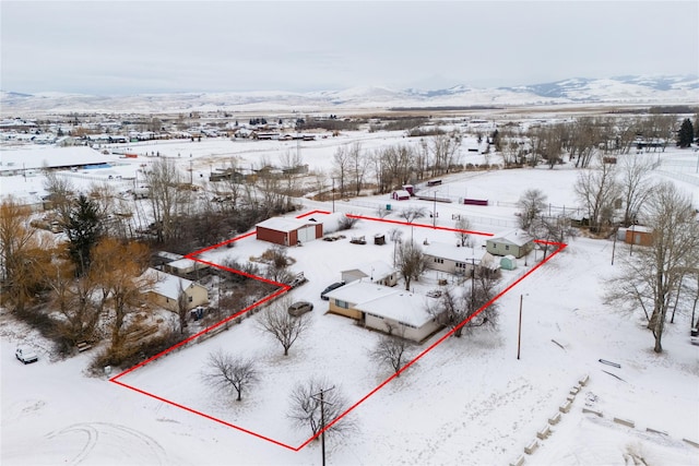 snowy aerial view with a mountain view