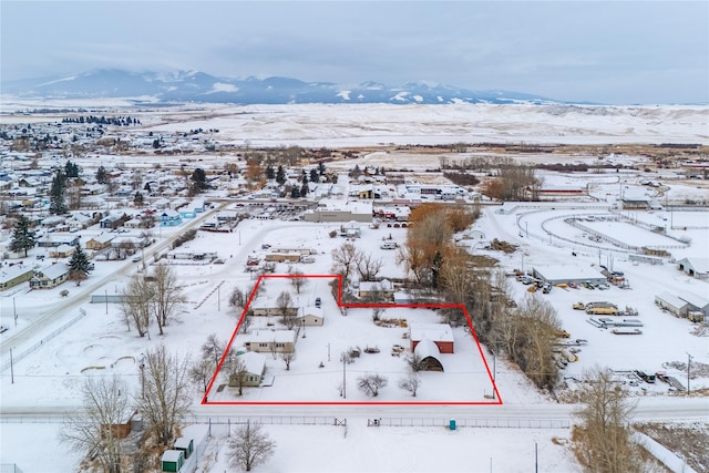 snowy aerial view with a mountain view