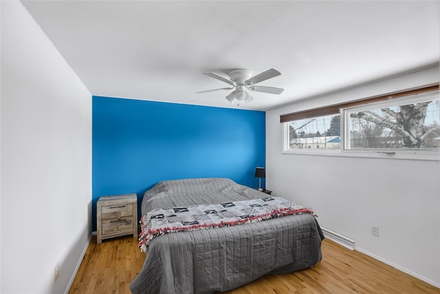 bedroom featuring hardwood / wood-style floors and ceiling fan