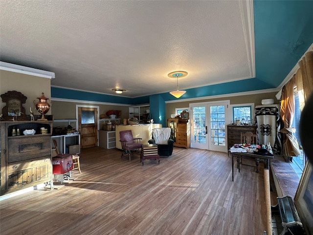 living room with french doors, a textured ceiling, and hardwood / wood-style flooring