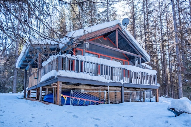 view of snow covered back of property