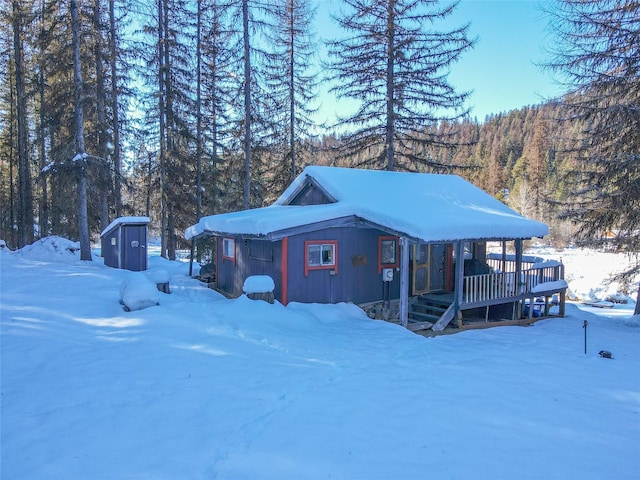 exterior space featuring a deck and a shed