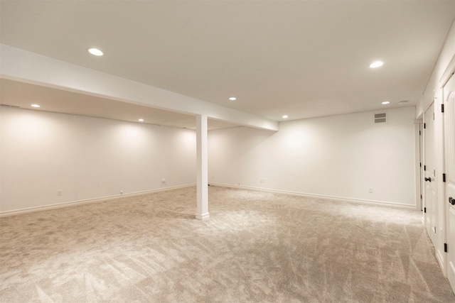 basement featuring light carpet