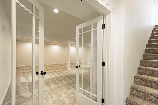 corridor with french doors and carpet flooring