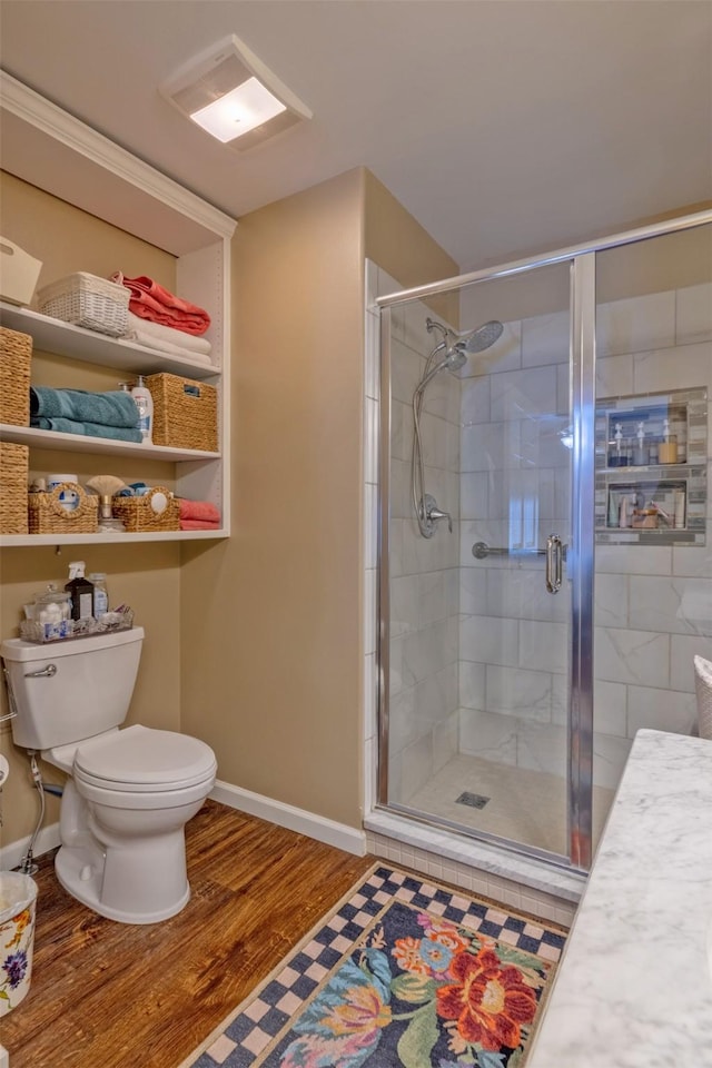 full bath with wood finished floors, a stall shower, visible vents, and toilet