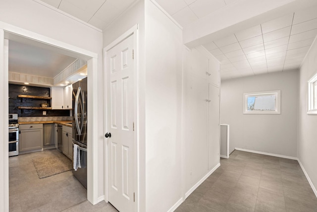 hallway featuring ornamental molding