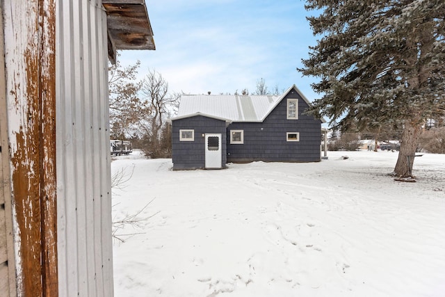 view of snow covered rear of property