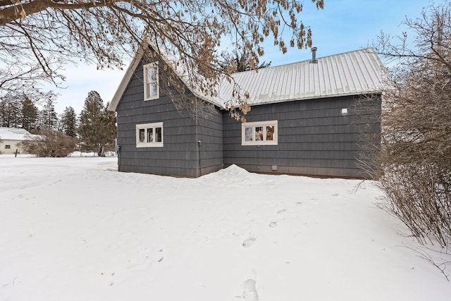 view of snow covered rear of property