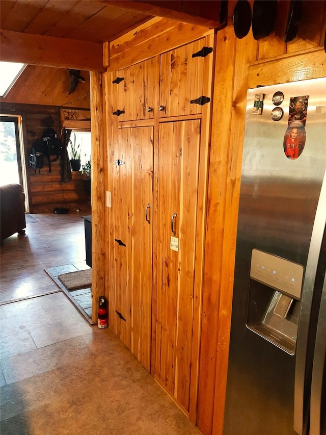 corridor with wooden walls, beam ceiling, and wooden ceiling