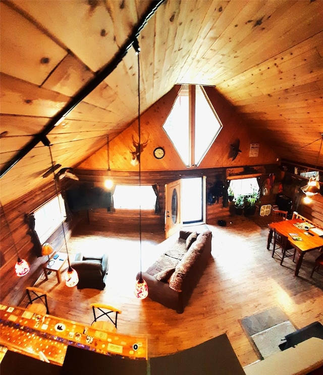 interior space with lofted ceiling, wood-type flooring, wooden ceiling, and wood walls