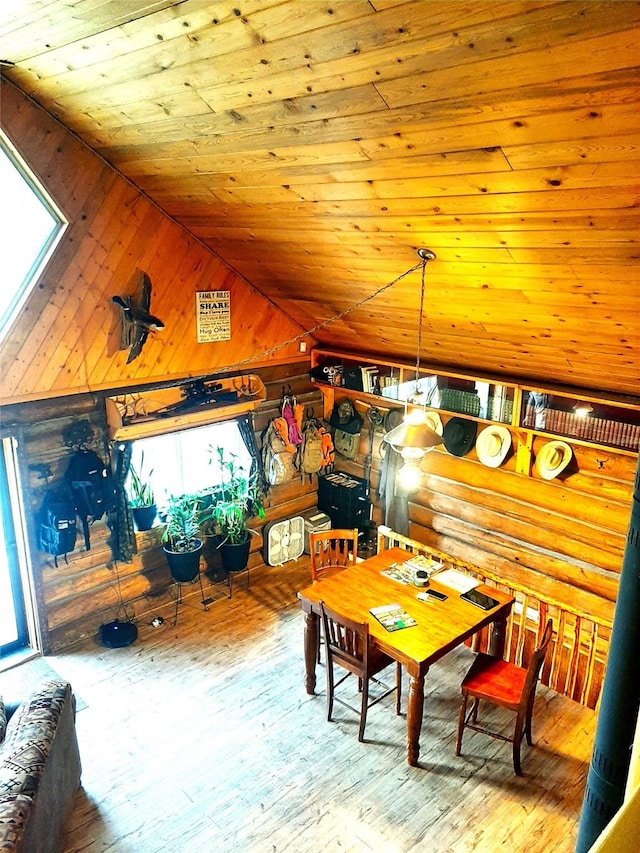 dining area featuring hardwood / wood-style flooring, wood ceiling, wooden walls, and rustic walls