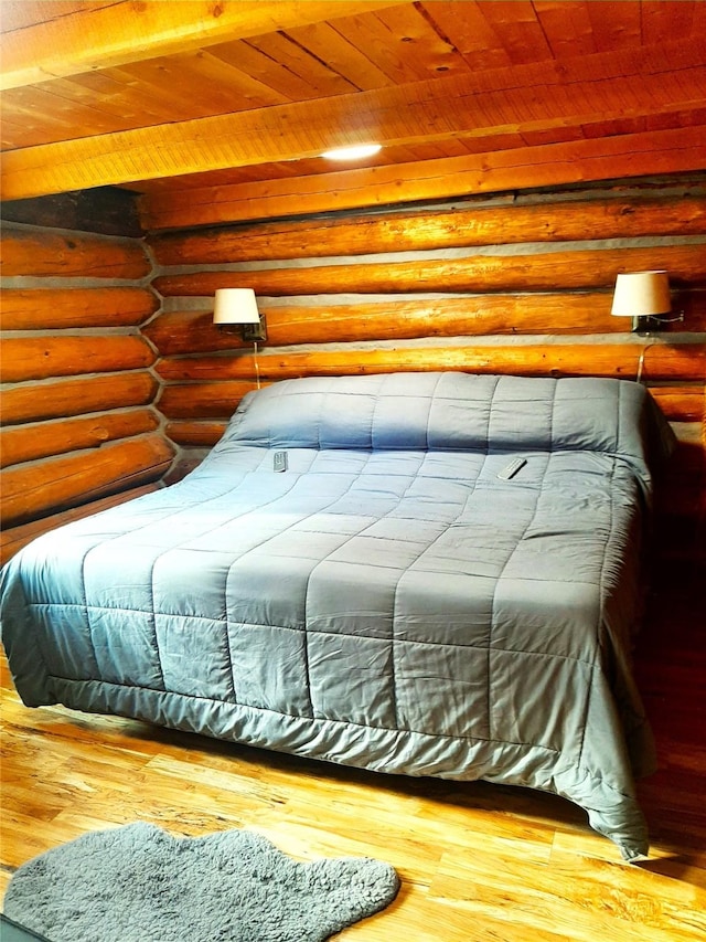 bedroom with wood ceiling, wood-type flooring, and rustic walls