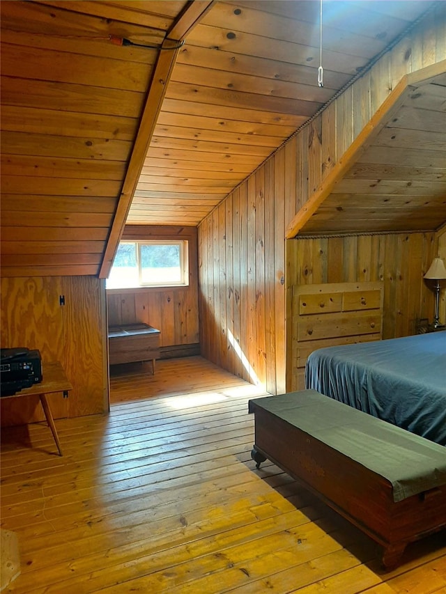 bedroom featuring lofted ceiling, wooden ceiling, wood walls, and light wood-type flooring