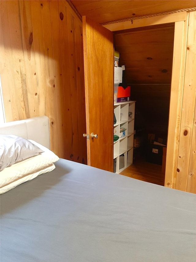 unfurnished bedroom featuring wood ceiling and wood walls