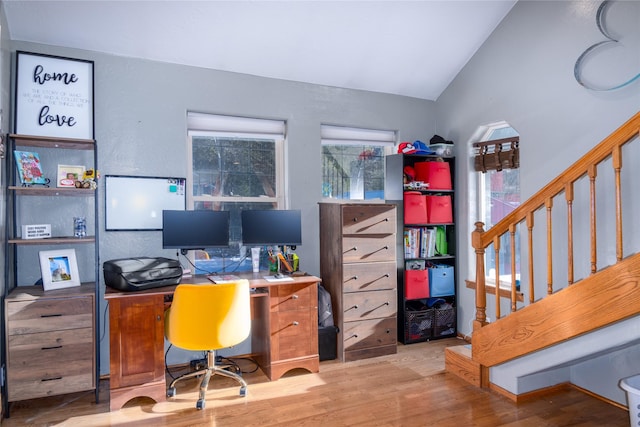 office with wood-type flooring and lofted ceiling