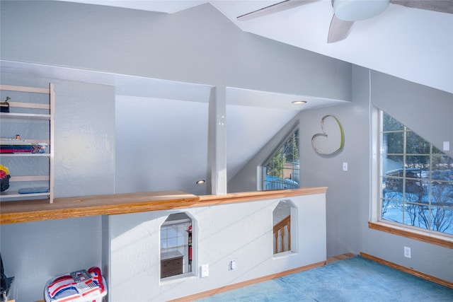 interior space featuring ceiling fan, lofted ceiling, and carpet