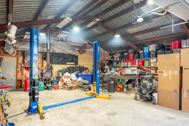 garage featuring a garage door opener and a workshop area