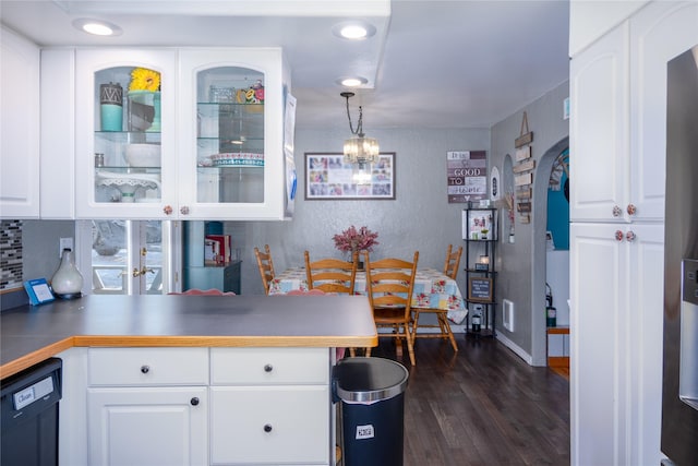 kitchen with dishwasher, dark hardwood / wood-style floors, pendant lighting, and white cabinets