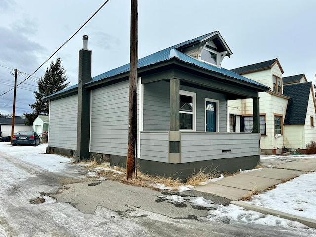 snow covered property featuring covered porch