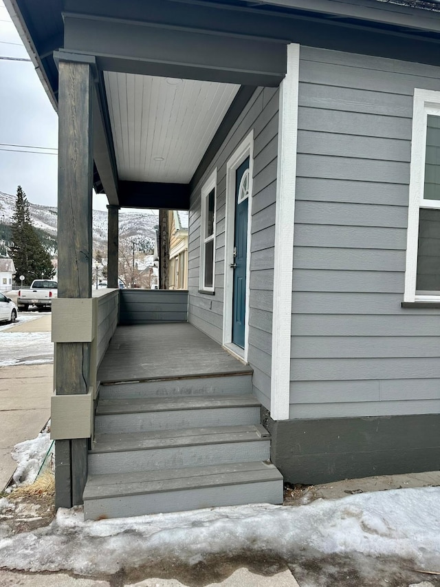 view of snow covered property entrance