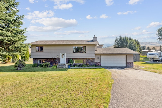 split foyer home with a garage and a front lawn