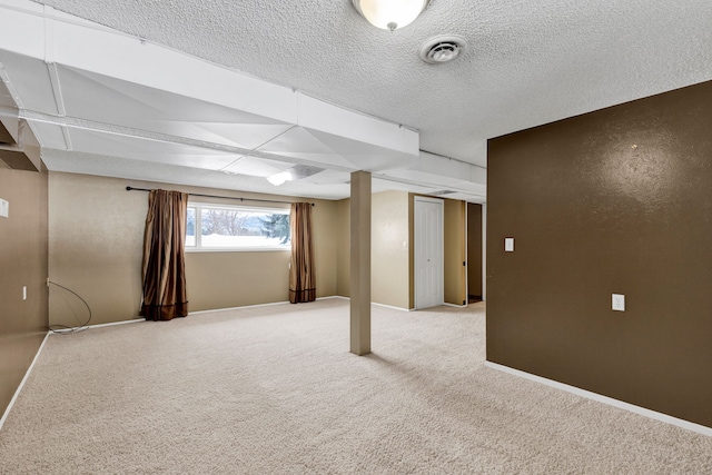 basement with a textured ceiling and carpet