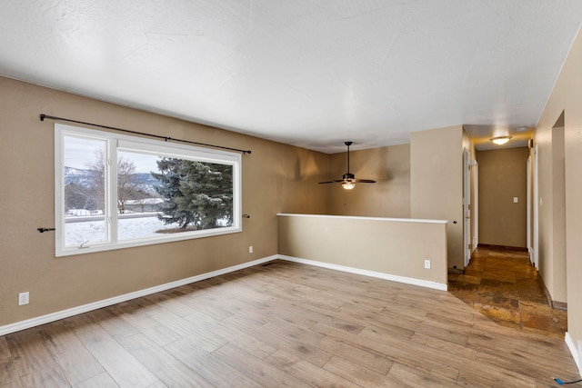 spare room featuring ceiling fan and light hardwood / wood-style floors