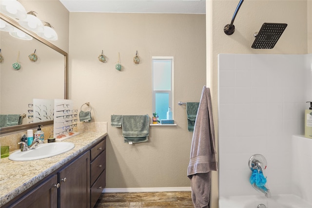 bathroom featuring vanity, wood-type flooring, and shower / bath combination