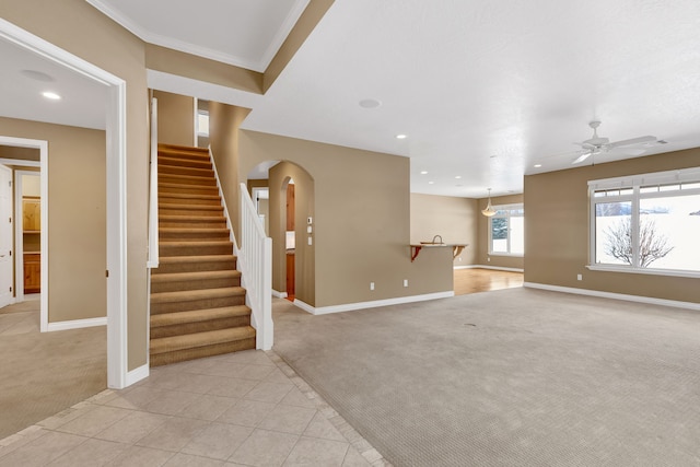 unfurnished living room featuring ceiling fan and light carpet