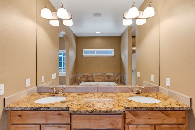 bathroom with vanity and a bathtub