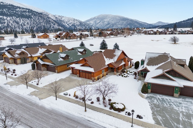 snowy aerial view featuring a mountain view