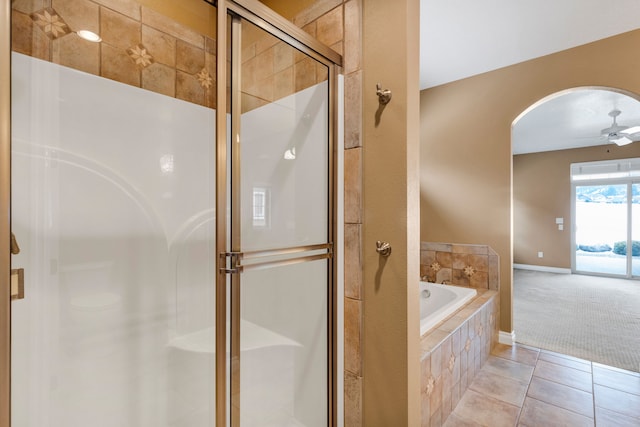 bathroom featuring tile patterned flooring, plus walk in shower, and ceiling fan