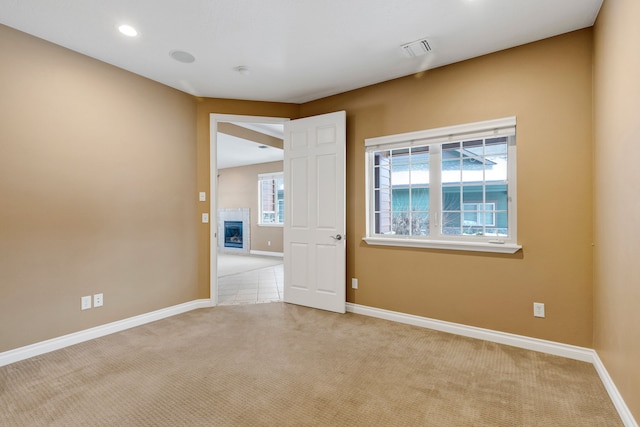 carpeted spare room with a healthy amount of sunlight