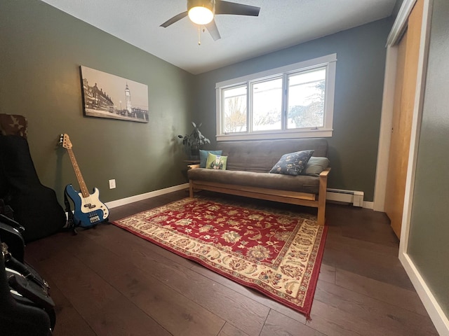 living area with ceiling fan, lofted ceiling, dark hardwood / wood-style flooring, and baseboard heating