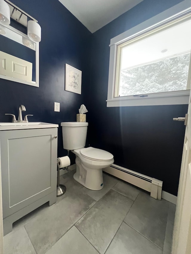 bathroom with vanity, toilet, tile patterned flooring, and a baseboard heating unit