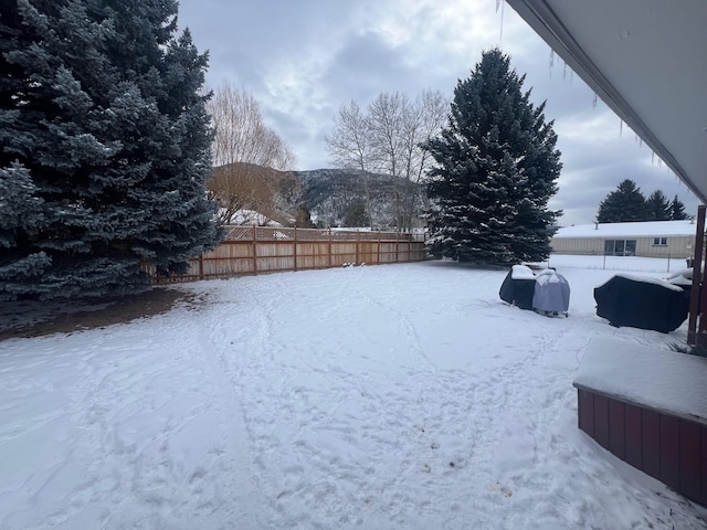 snowy yard featuring a mountain view