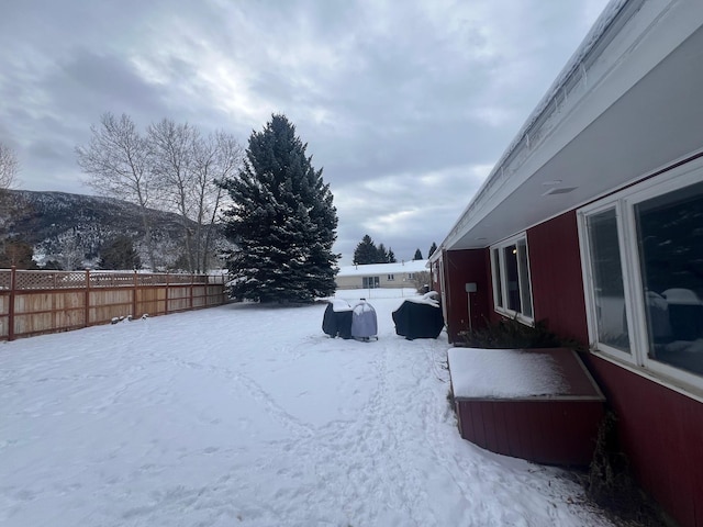 yard covered in snow with a mountain view