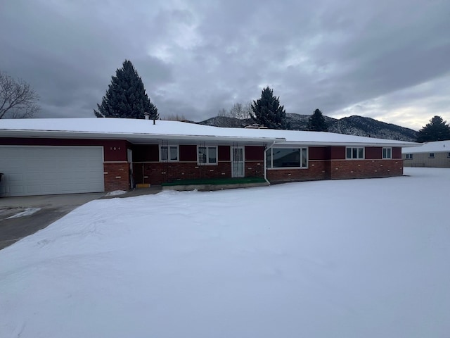 single story home with a garage and a mountain view