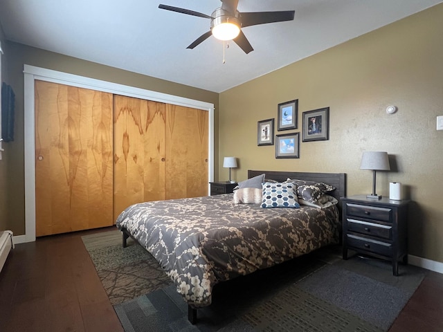 bedroom with dark wood-type flooring, a closet, and ceiling fan