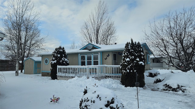 view of front of property featuring a storage shed