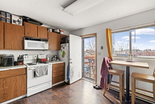 kitchen featuring dark hardwood / wood-style flooring and white appliances