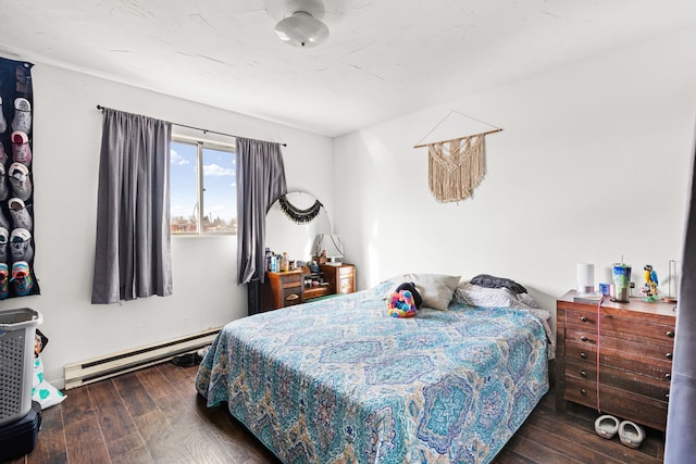 bedroom featuring a baseboard heating unit and dark hardwood / wood-style floors