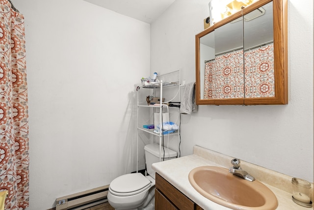 bathroom with vanity, toilet, and a baseboard heating unit