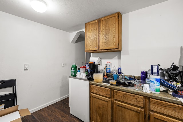 kitchen featuring dark hardwood / wood-style floors and a textured ceiling