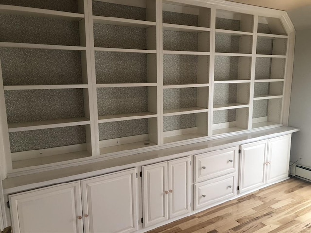 interior details with a baseboard radiator and wood finished floors