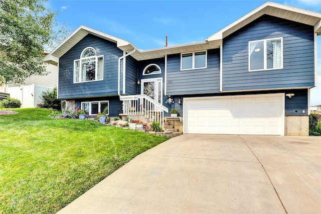 split foyer home with a garage and a front lawn